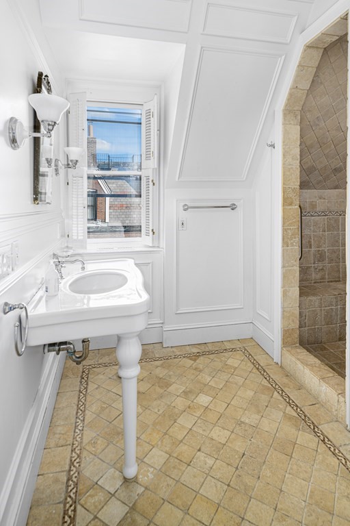 1 Otis Place Boston, MA 02108 - Photo 13 of 22 a bathroom with a sink a mirror and a shower