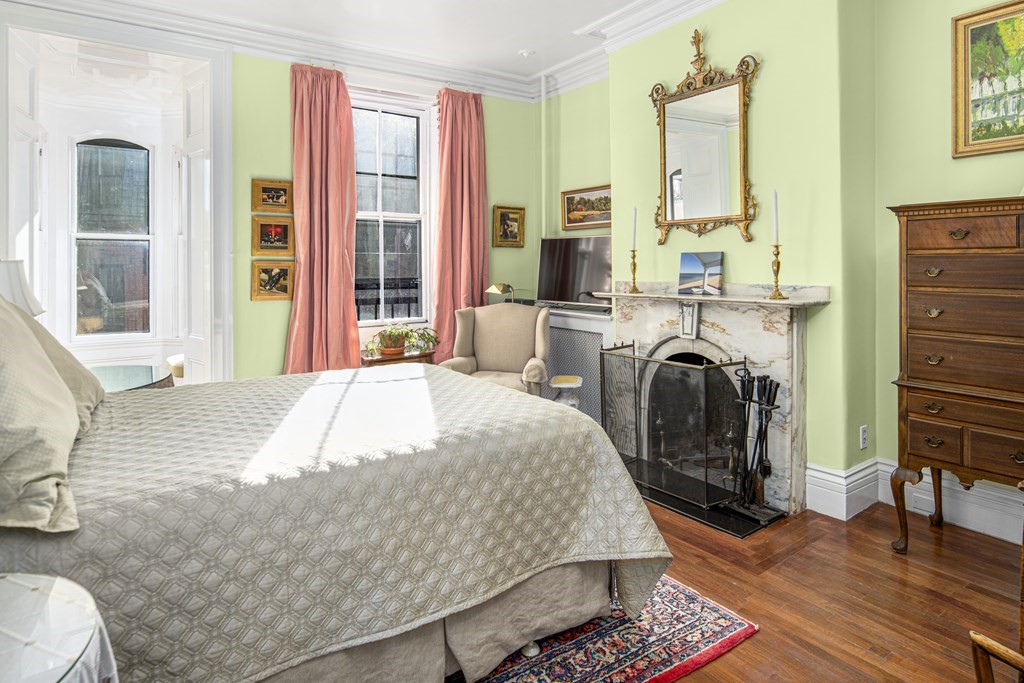 1 Otis Place Boston, MA 02108 - Photo 7 of 22 a bedroom with a bed a table and chair