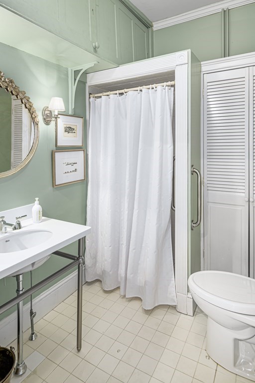 1 Otis Place Boston, MA 02108 - Photo 10 of 22 a view of a bathroom with a sink and a mirror