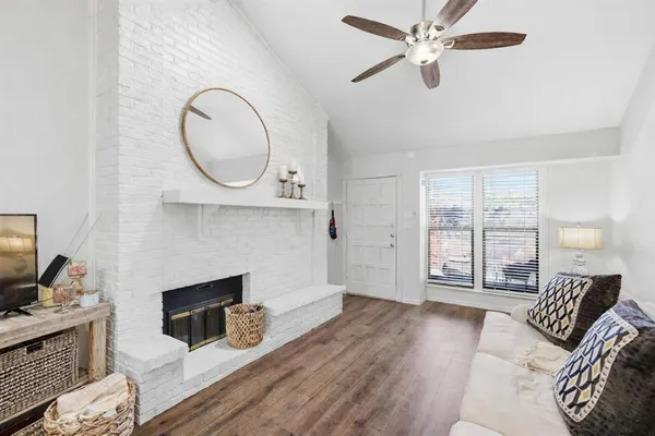 a living room with furniture a fireplace and a flat screen tv