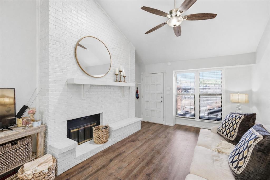 a living room with furniture a fireplace and a flat screen tv