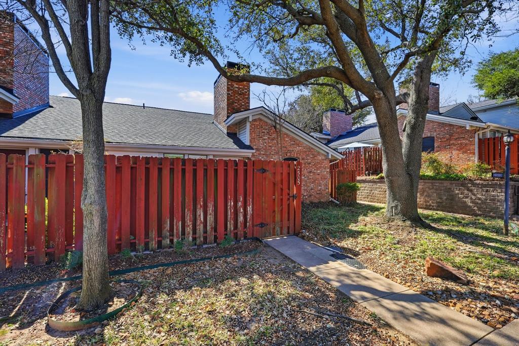 2505 Shady Ridge Drive Bedford, TX 76021 - Photo 15 of 15 a view of a house with a large tree and wooden fence