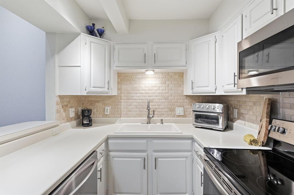 2505 Shady Ridge Drive Bedford, TX 76021 - Photo 3 of 15 a kitchen with a sink cabinets and stainless steel appliances