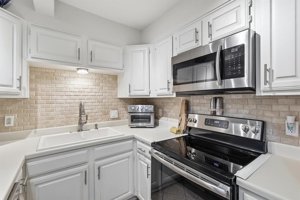 2505 Shady Ridge Drive Bedford, TX 76021 - Photo 4 of 15 a kitchen with cabinets stainless steel appliances and a sink