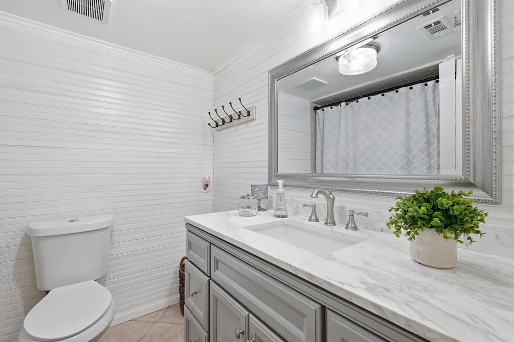 2505 Shady Ridge Drive Bedford, TX 76021 - Photo 10 of 15 a bathroom with a sink a toilet and mirror