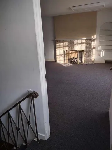 a view of a hallway with seating area