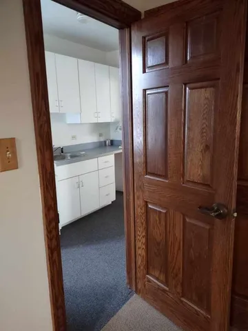a kitchen with a refrigerator and cabinets