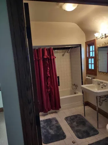 a bathroom with a sink a toilet a bathtub and vanity