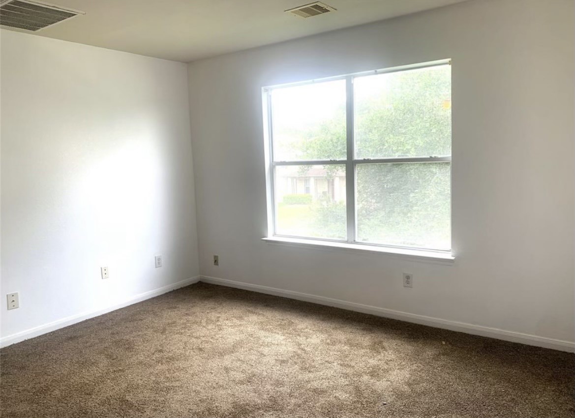 8154 Arrington Forest Lane Humble, TX 77338 - Photo 7 of 10 an empty room with a window