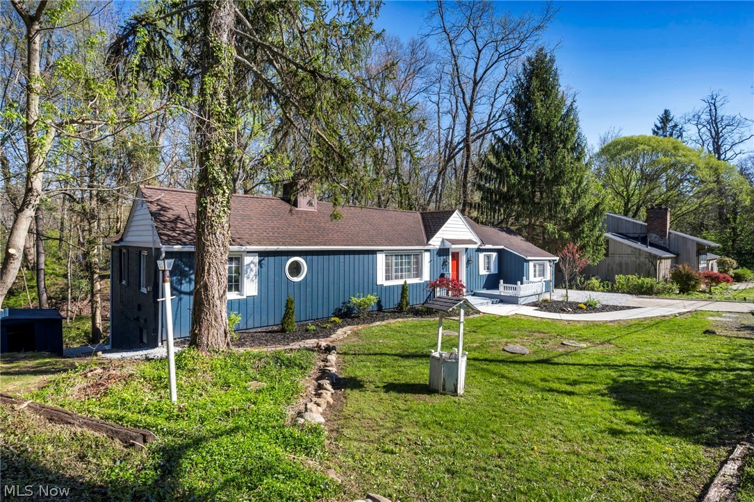 7339 River Road Olmsted Falls, OH 44138 - Photo 4 of 45 Blue exterior siding with white trim and a contrasting red front door