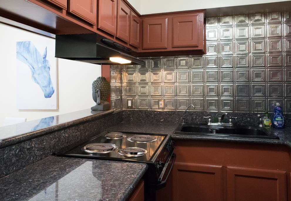 3942 West Alabama Street, Unit 5 Houston, TX 77027 - Photo 12 of 28 a room with granite countertop a sink and a stove
