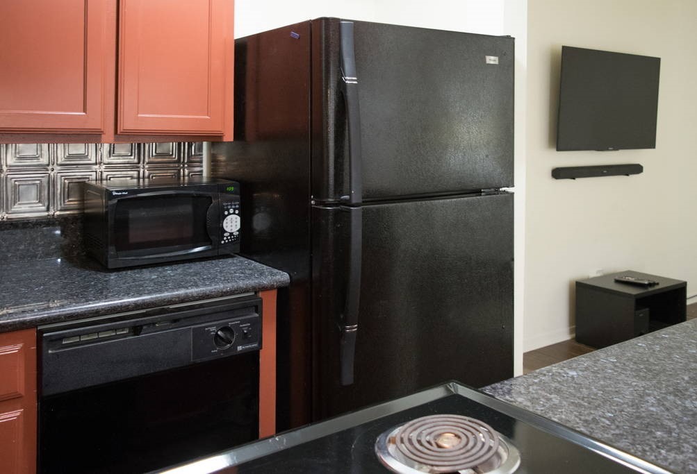 3942 West Alabama Street, Unit 5 Houston, TX 77027 - Photo 13 of 28 a kitchen with a refrigerator and a stove