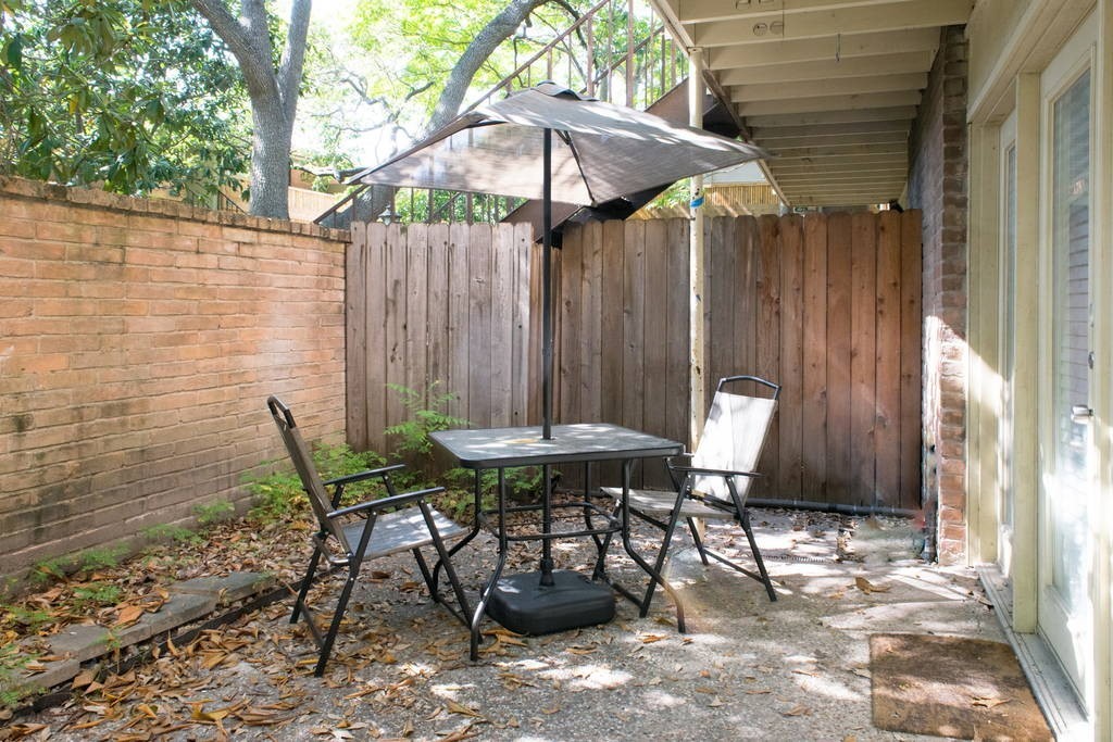 3942 West Alabama Street, Unit 5 Houston, TX 77027 - Photo 14 of 28 a backyard of a house with table and chairs