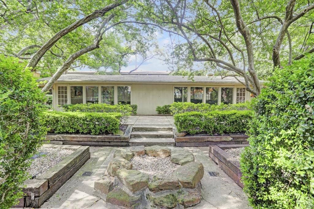 3942 West Alabama Street, Unit 5 Houston, TX 77027 - Photo 16 of 28 a front view of a house with a yard and potted plants