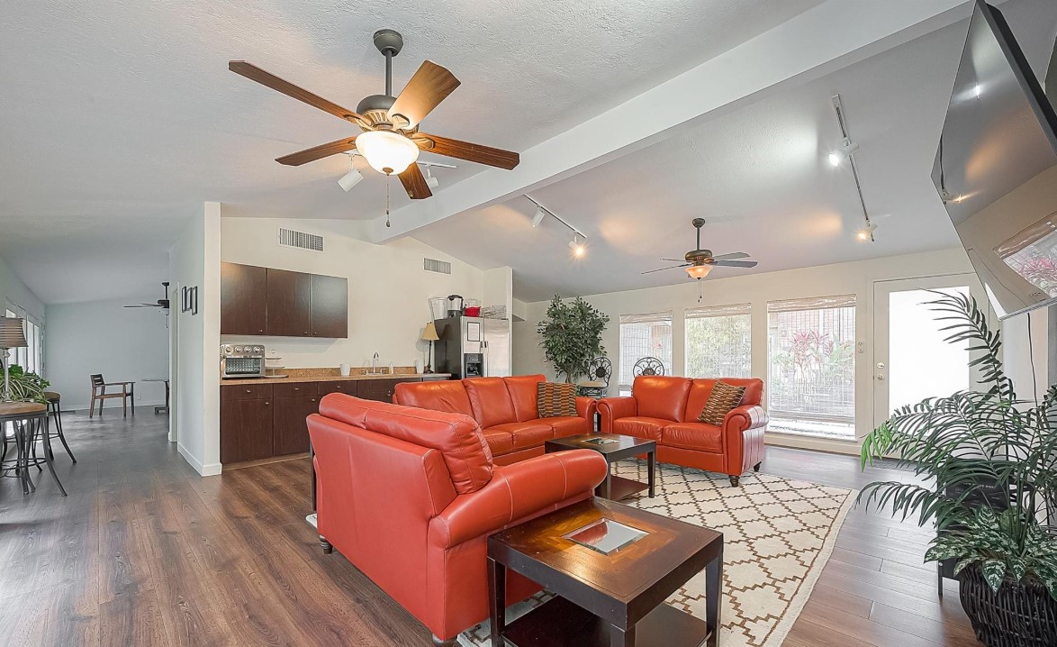 3942 West Alabama Street, Unit 5 Houston, TX 77027 - Photo 19 of 28 a living room with furniture a flat screen tv and a floor to ceiling window