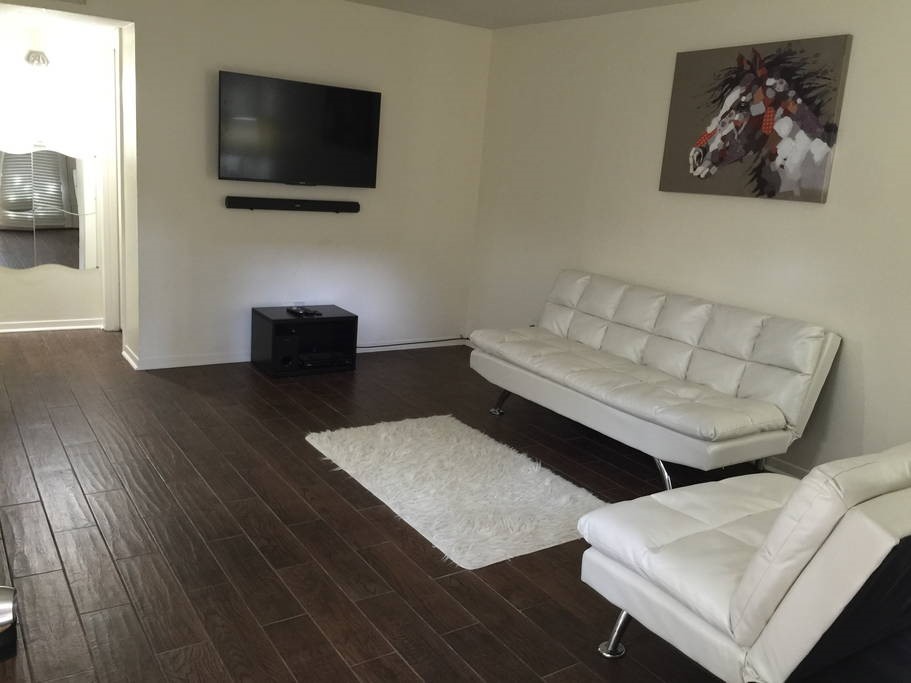 3942 West Alabama Street, Unit 5 Houston, TX 77027 - Photo 3 of 28 a living room with furniture and a flat screen tv