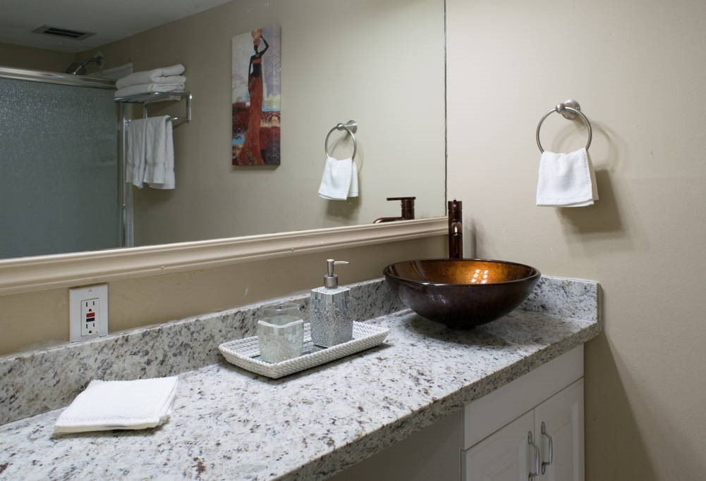 3942 West Alabama Street, Unit 5 Houston, TX 77027 - Photo 9 of 28 a kitchen with a sink and a stove with wooden floor