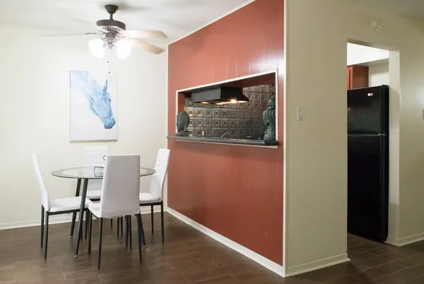 a room with granite countertop a sink and a stove
