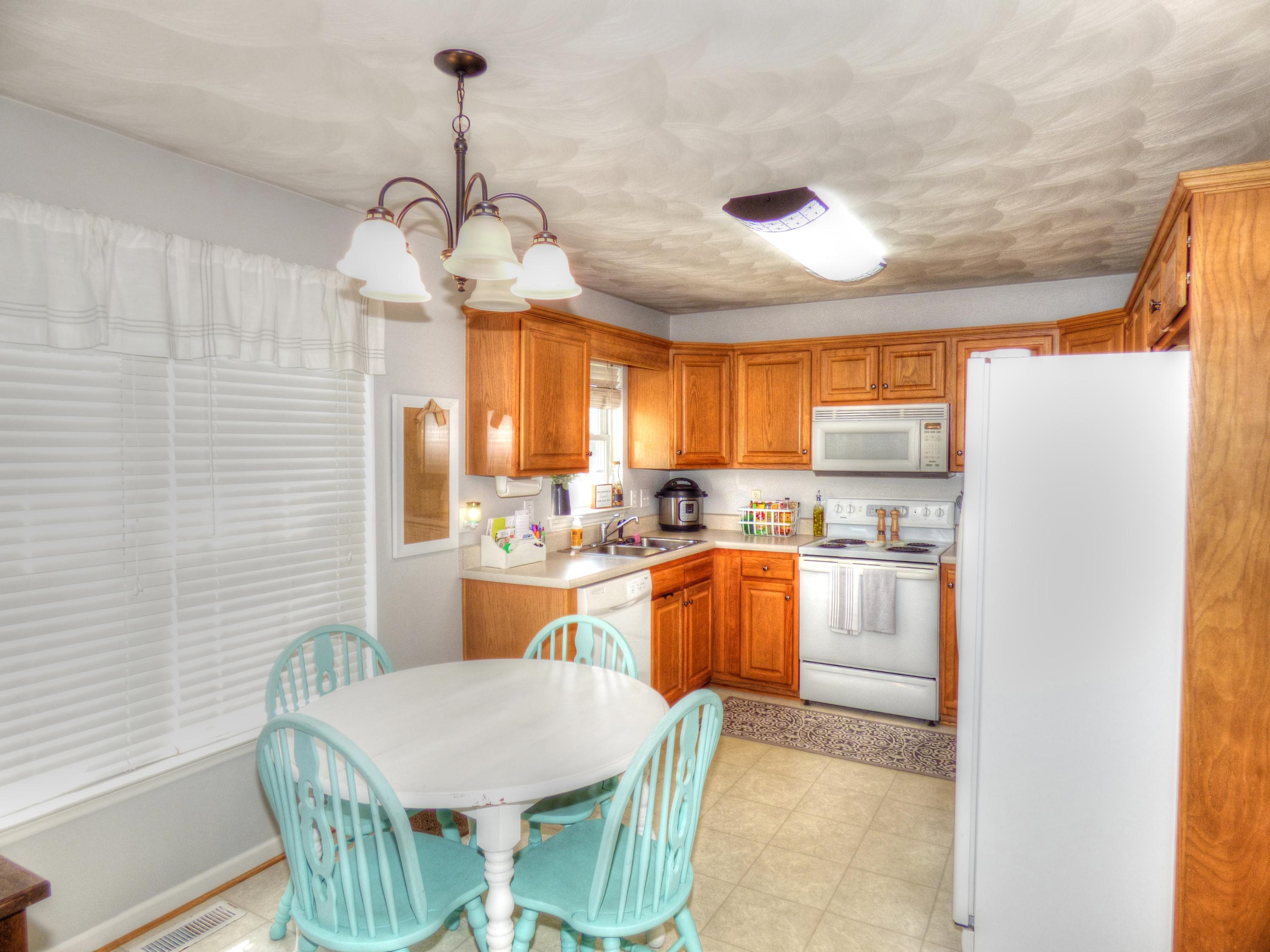 819 Ruddell Road Vinton, VA 24179 - Photo 11 of 22 a kitchen with stainless steel appliances granite countertop a kitchen island a stove a table and chairs