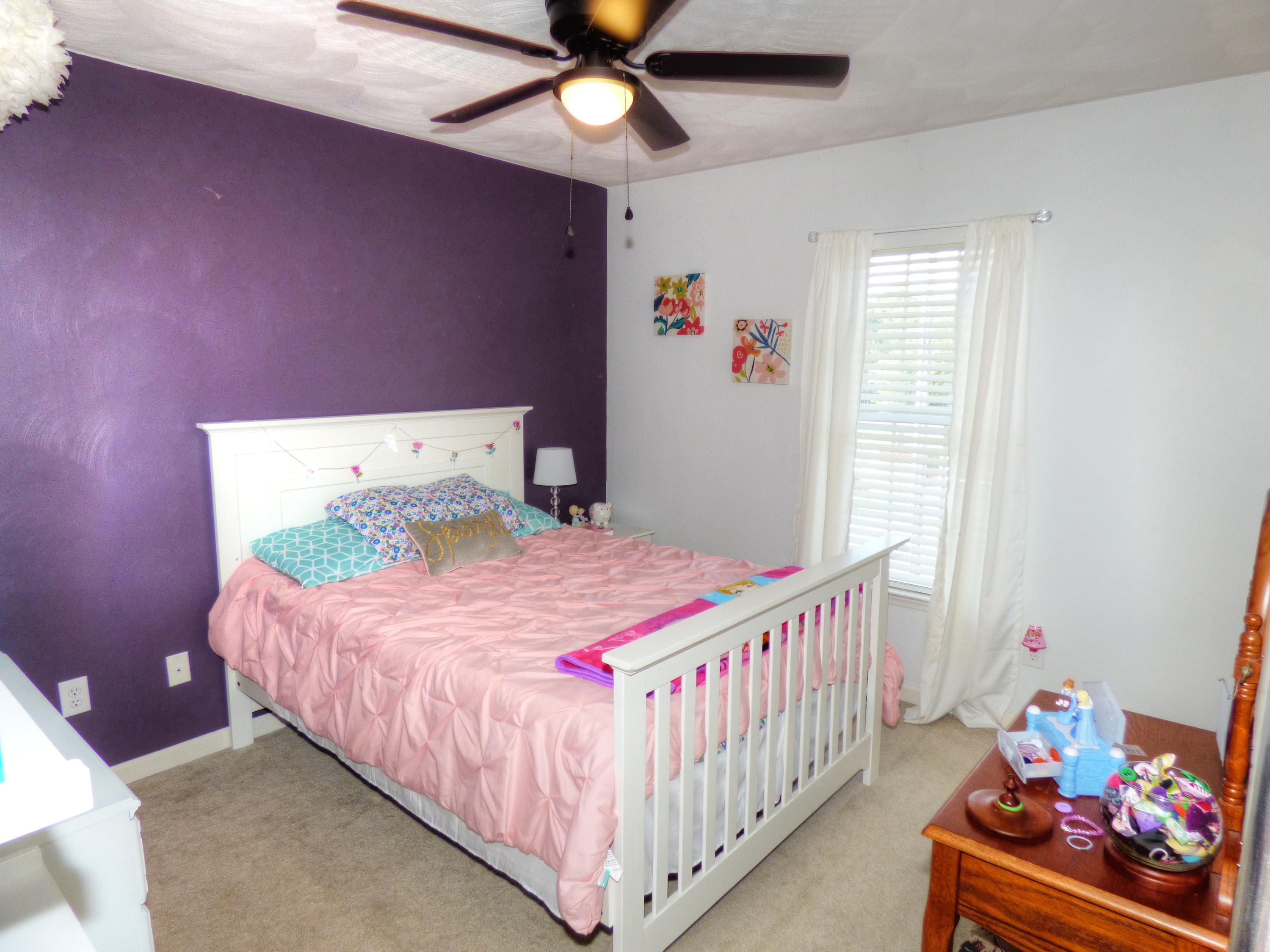 819 Ruddell Road Vinton, VA 24179 - Photo 17 of 22 a bedroom with a bed and a chandelier