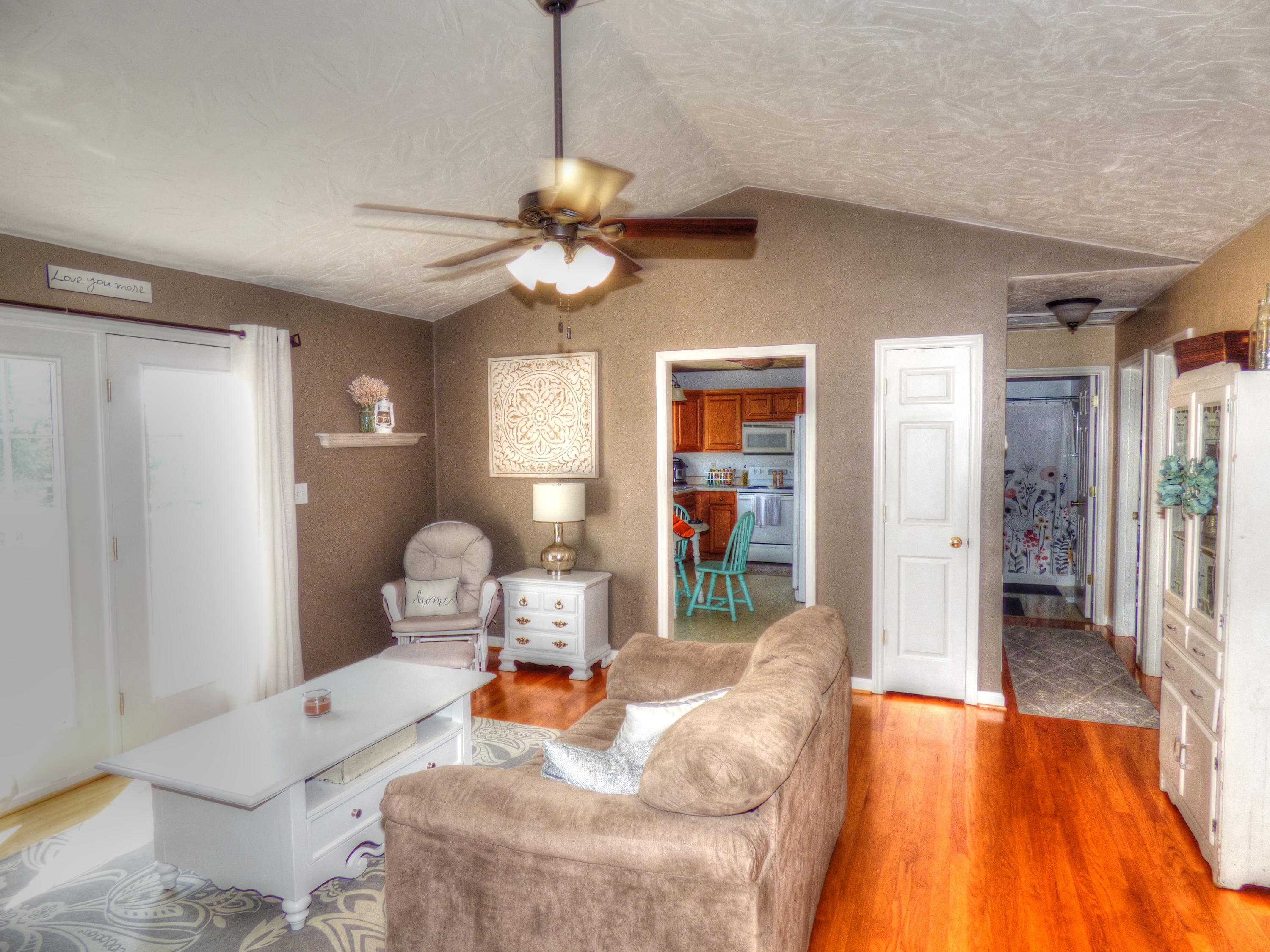 819 Ruddell Road Vinton, VA 24179 - Photo 9 of 22 a living room with furniture and a chandelier