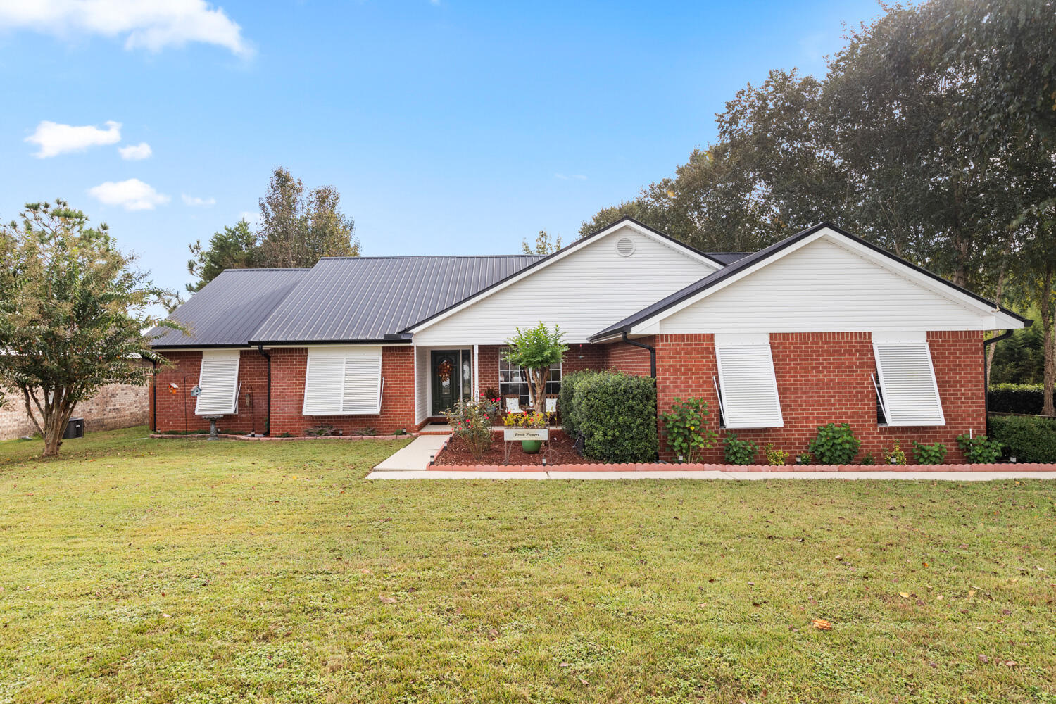 a front view of a house with garden