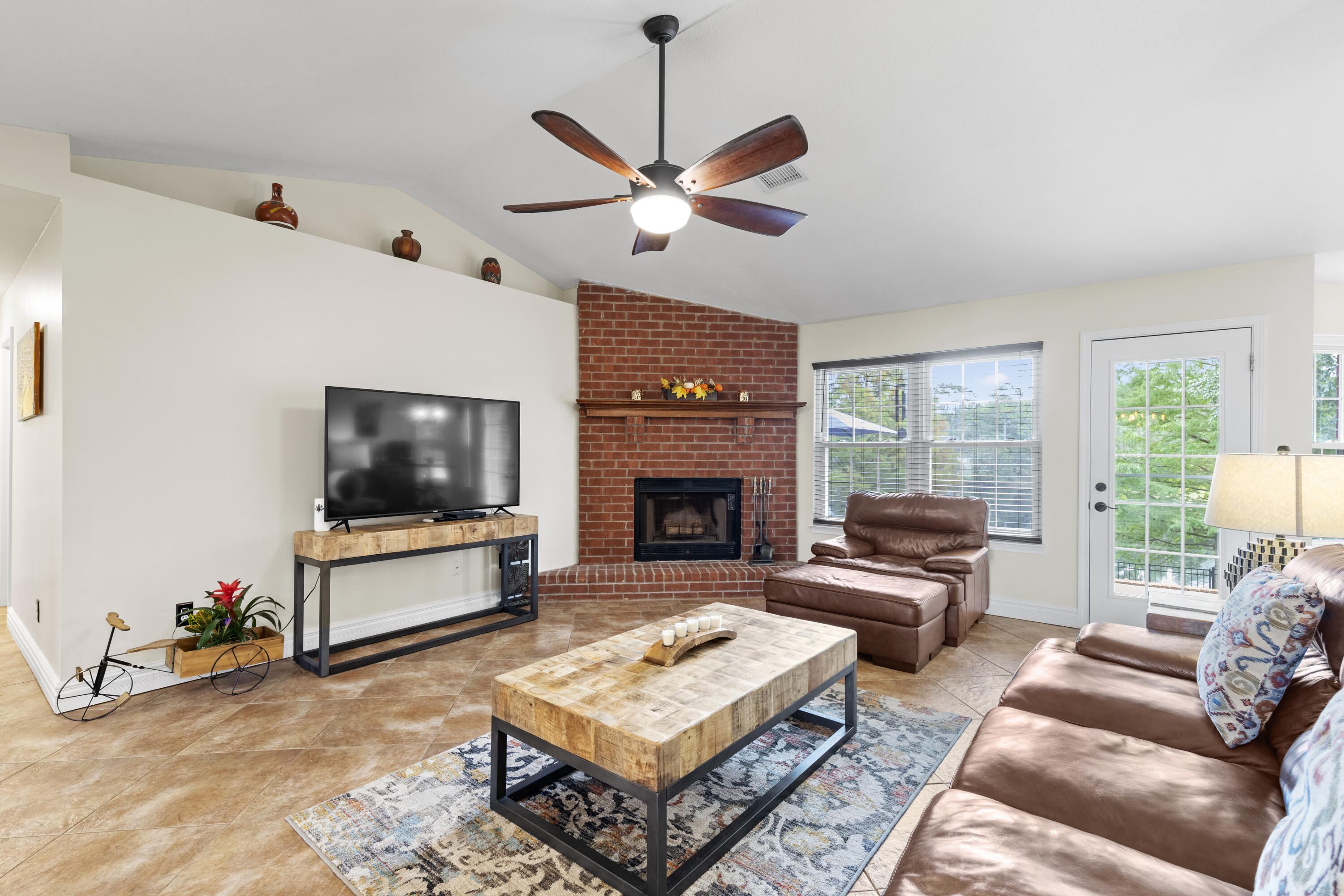 2852 Atoka Trail Crestview, FL 32539 - Photo 16 of 45 a living room with furniture a flat screen tv and a fireplace