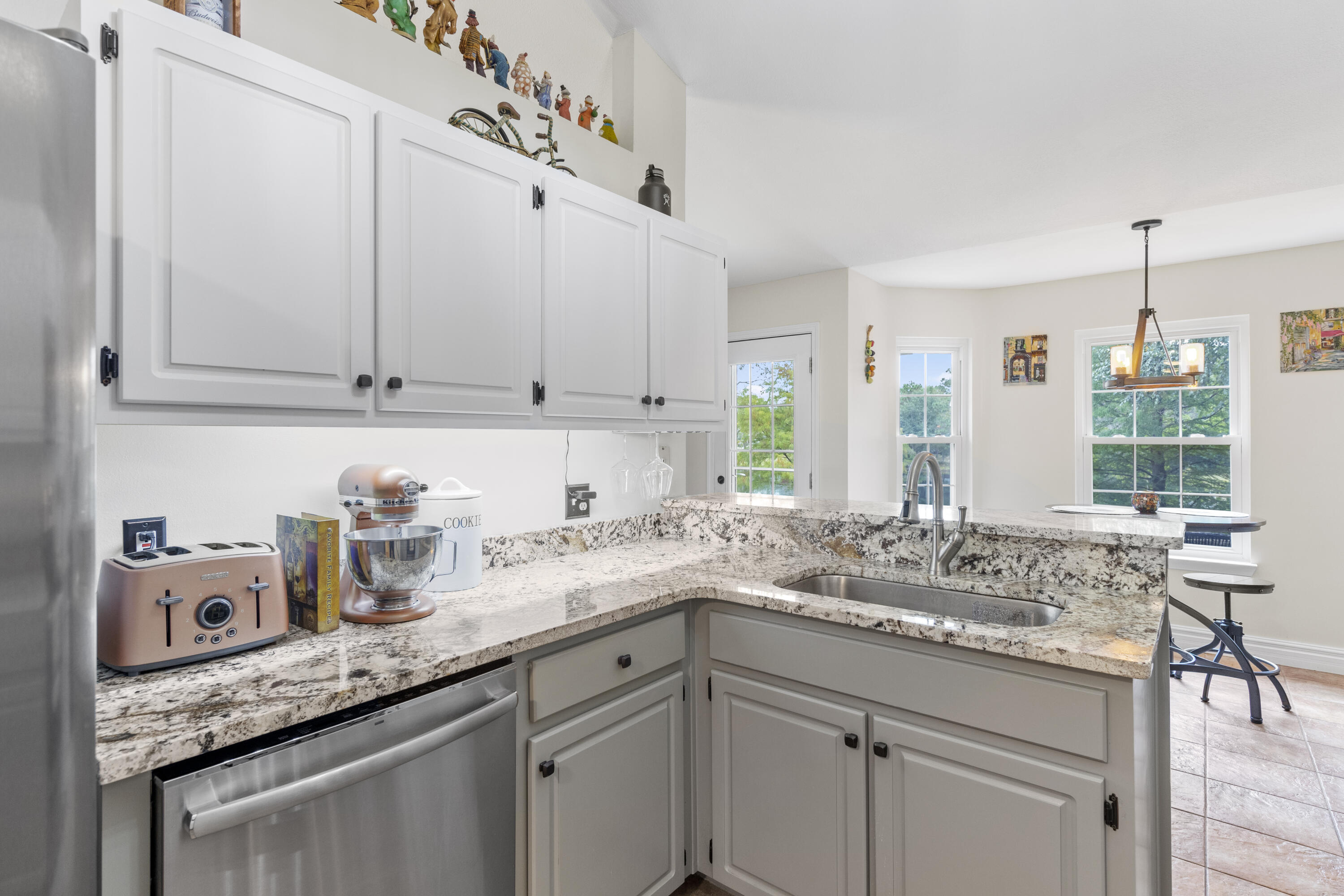 2852 Atoka Trail Crestview, FL 32539 - Photo 22 of 45 a kitchen with stainless steel appliances granite countertop a sink and dishwasher with white cabinets