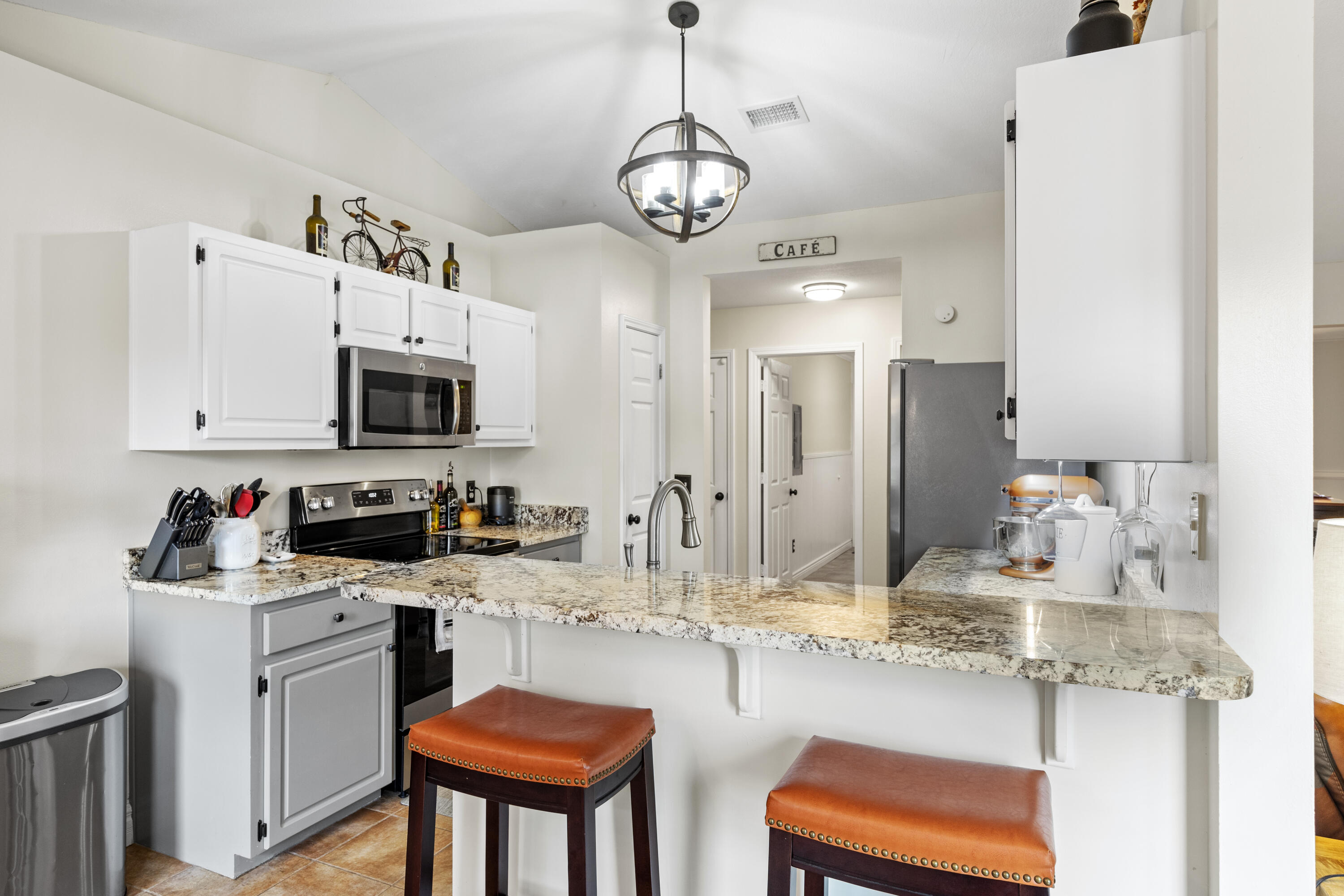 2852 Atoka Trail Crestview, FL 32539 - Photo 23 of 45 a kitchen with stainless steel appliances kitchen island granite countertop a sink dishwasher and a stove with wooden floor