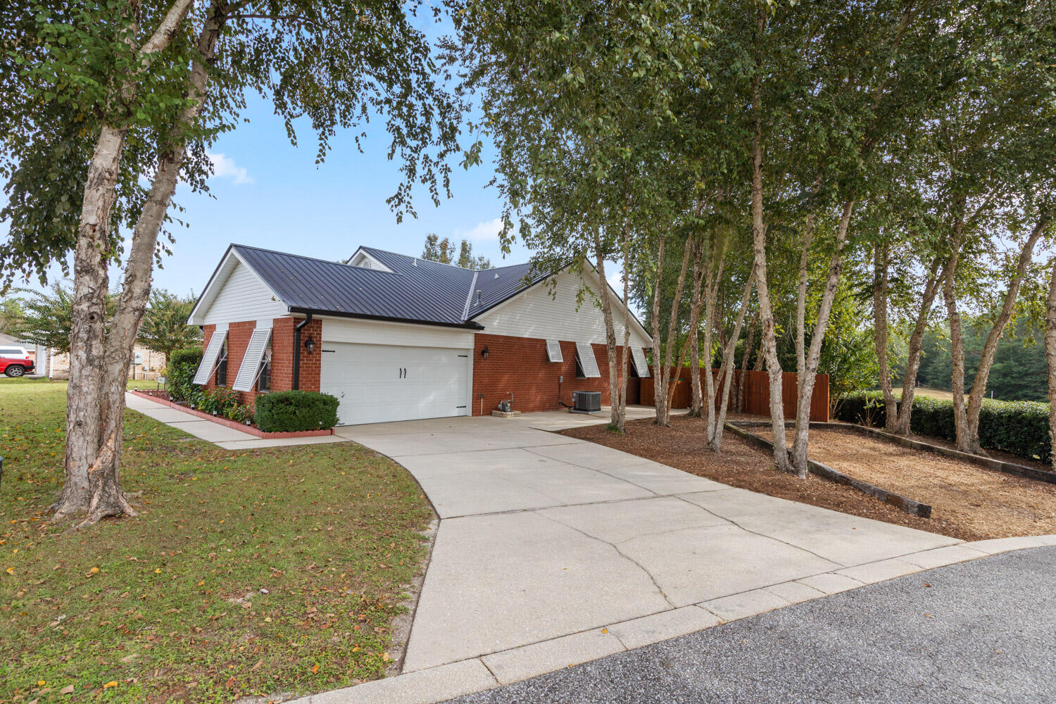2852 Atoka Trail Crestview, FL 32539 - Photo 5 of 45 a view of a house with large tree and wooden fence