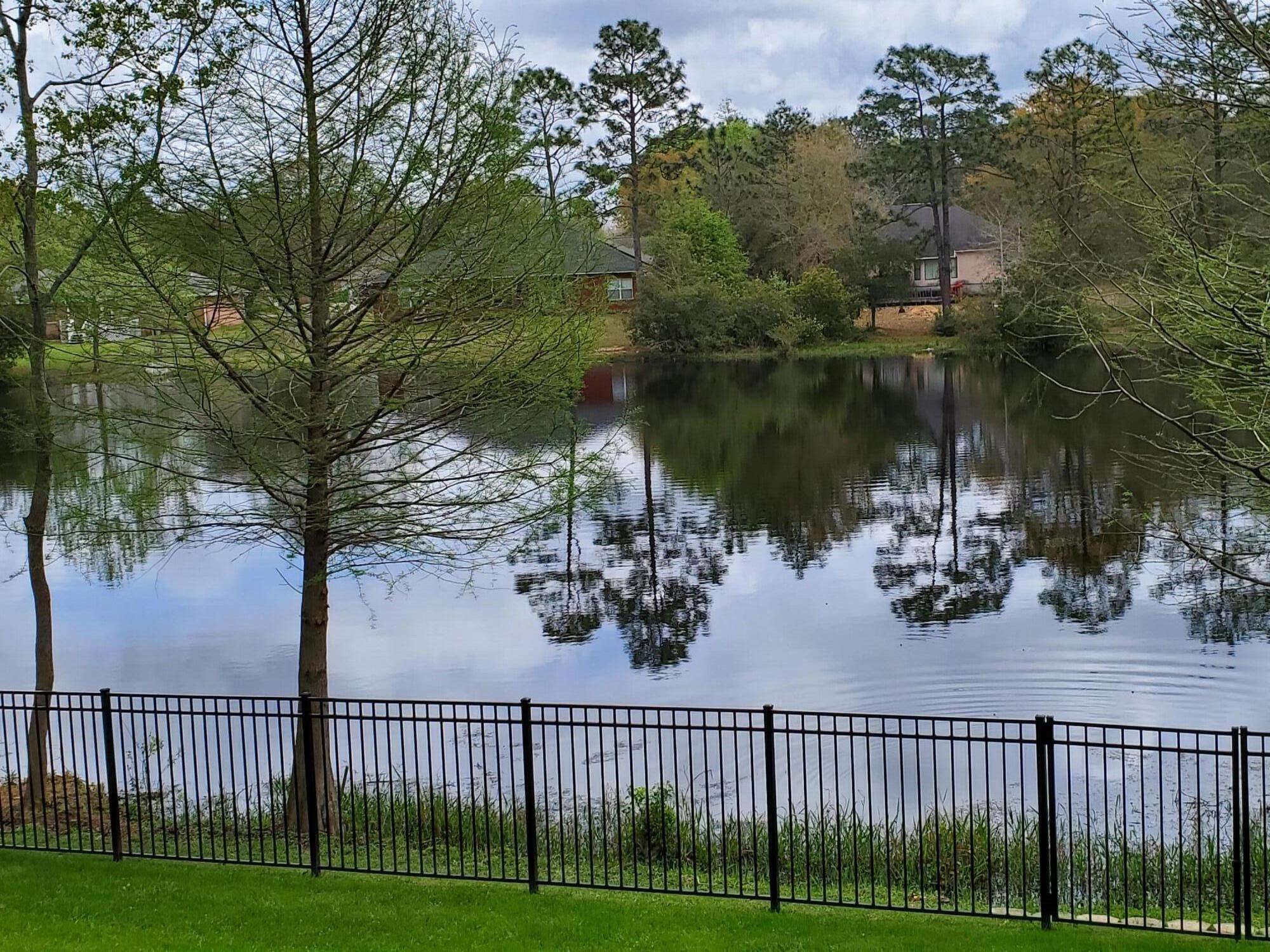2852 Atoka Trail Crestview, FL 32539 - Photo 44 of 45 a view of a lake with a garden