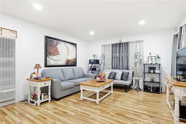 a living room with furniture a flat screen tv and a rug