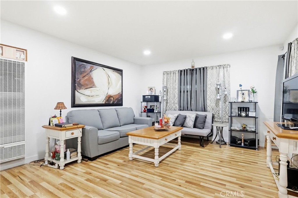 924 West 134th Place Compton, CA 90222 - Photo 12 of 45 a living room with furniture a flat screen tv and a rug