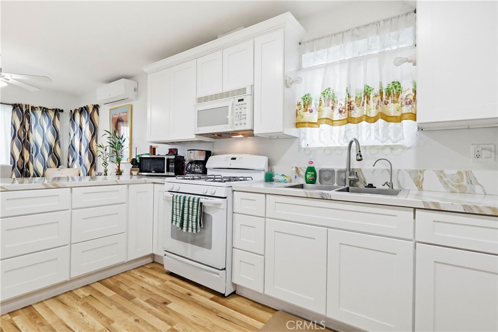 924 West 134th Place Compton, CA 90222 - Photo 20 of 45 a kitchen with a sink window and cabinets