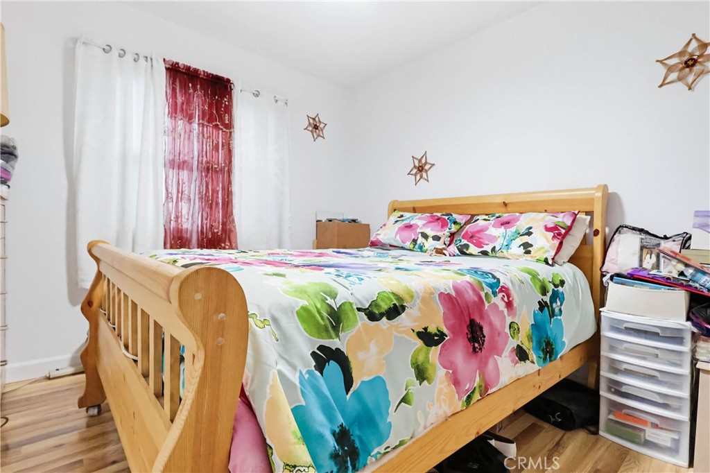 924 West 134th Place Compton, CA 90222 - Photo 21 of 45 a bedroom with a bed and a painting on the wall