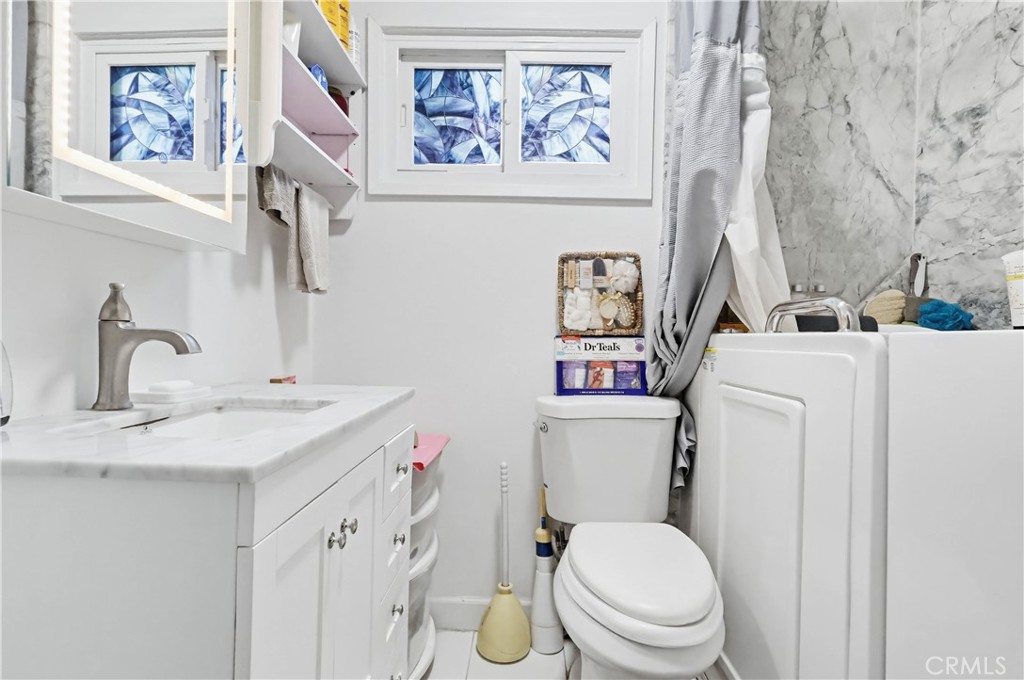 924 West 134th Place Compton, CA 90222 - Photo 26 of 45 a bathroom with a toilet sink and mirror