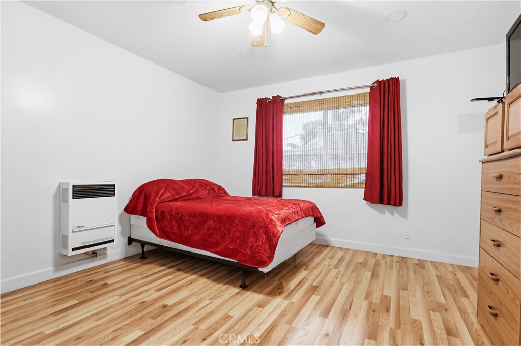 924 West 134th Place Compton, CA 90222 - Photo 27 of 45 a bedroom with a bed and wooden floor