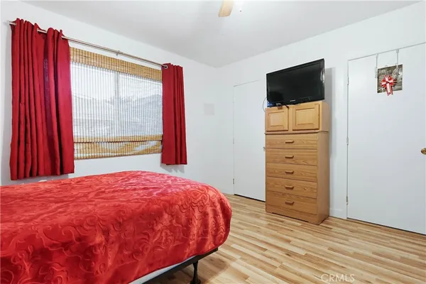 a bed sitting in a bedroom next to a window