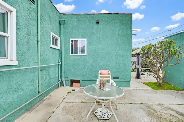 a backyard of a house with table and chairs