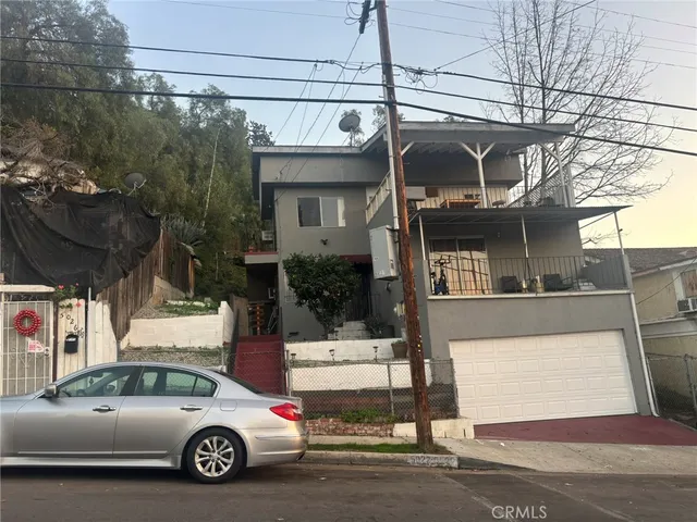 a view of a car parked in front of a house