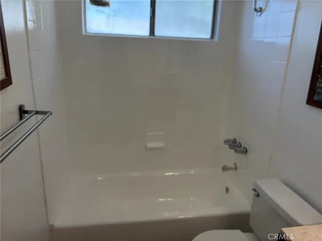 a bathroom with a bathtub and toilet