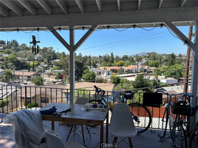 a view of a balcony dining table and chairs