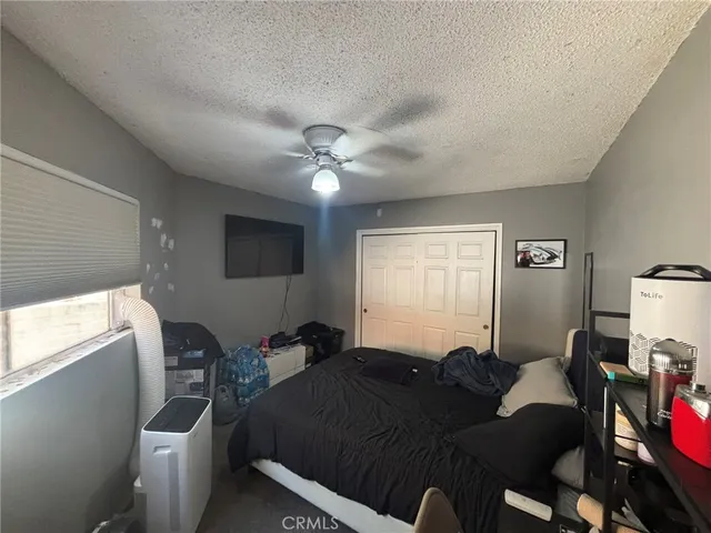a living room with furniture a flat screen tv and a window