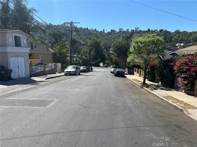 a view of a street with a parked cars