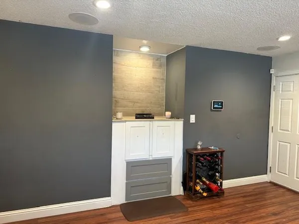 a view of room with wooden floor