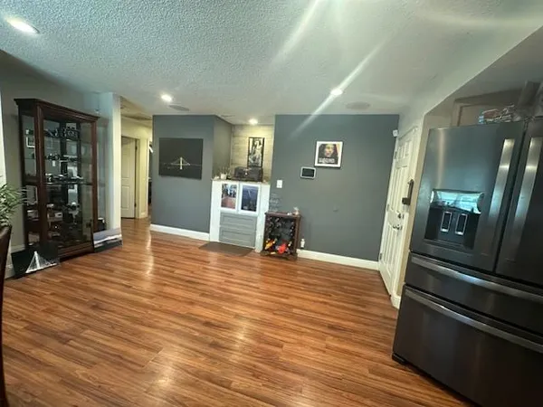 a view of a living room with furniture and wooden floor