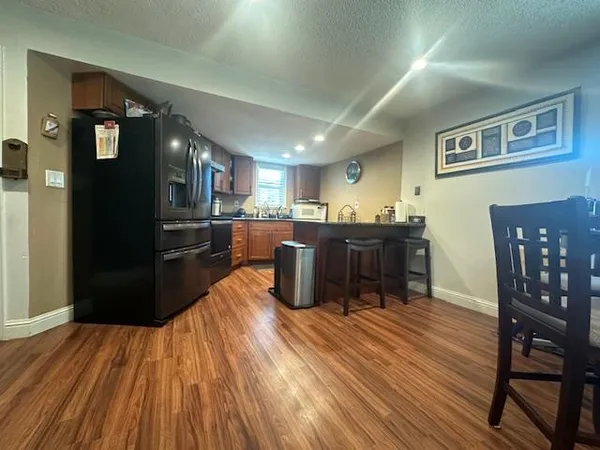 a kitchen with stainless steel appliances wooden floors and wooden cabinets