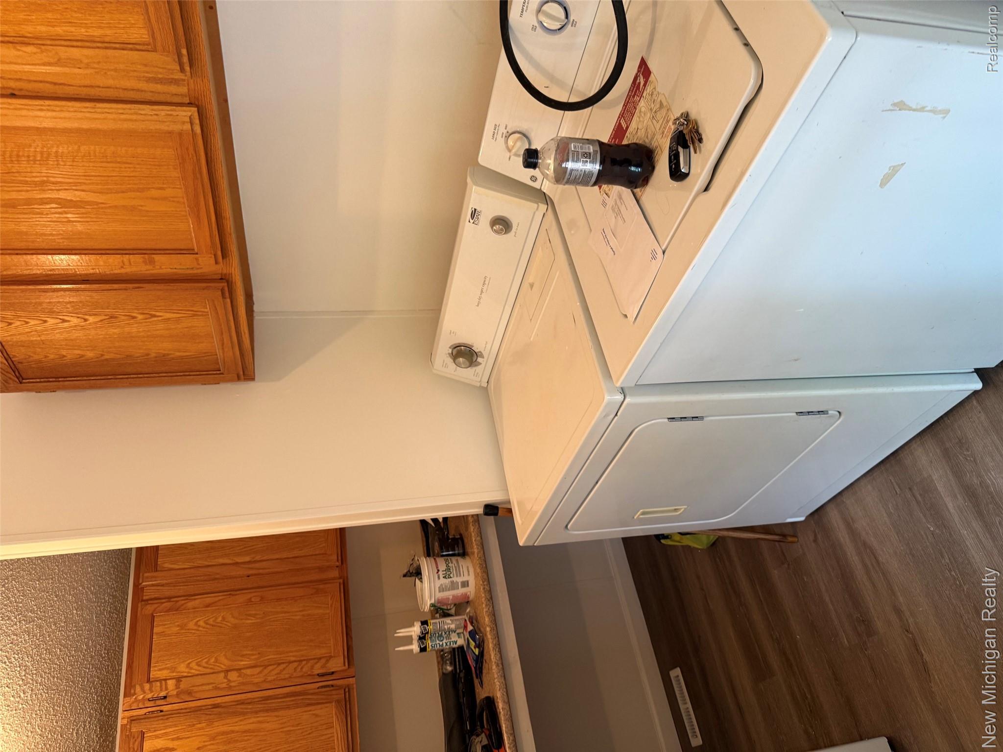 1446 Wheeler Road Allenton, MI 48002 - Photo 20 of 22 Wood-finish flooring with overhead wood cabinetry and a built-in counter