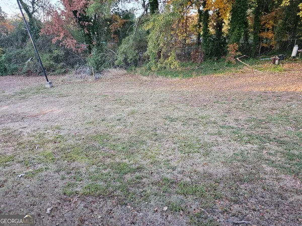 a view of a yard with a tree