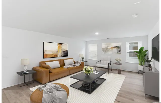 a living room with furniture and wooden floor